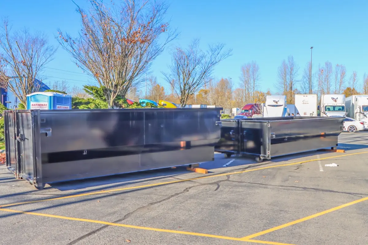 Professional dumpster rental service with roll-off container on residential driveway in Nether Providence